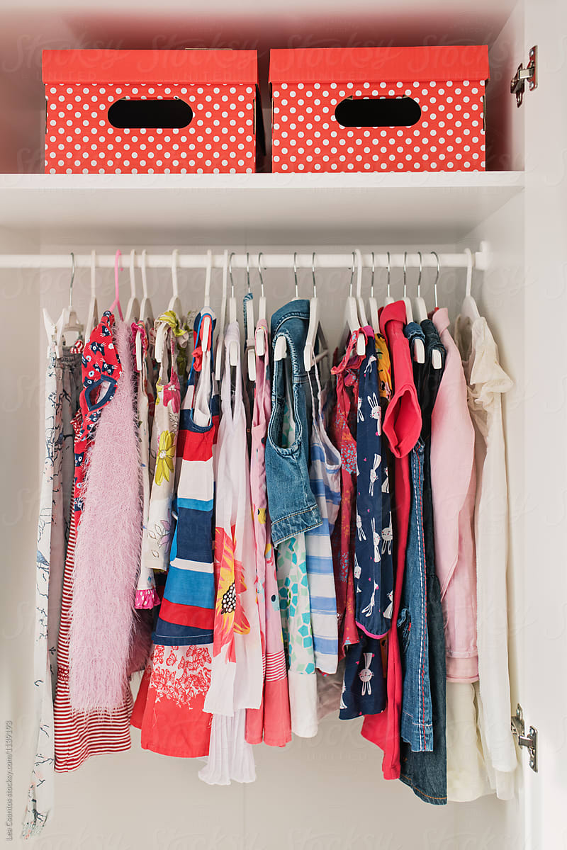 Girl\'s dresses hanging in a closet