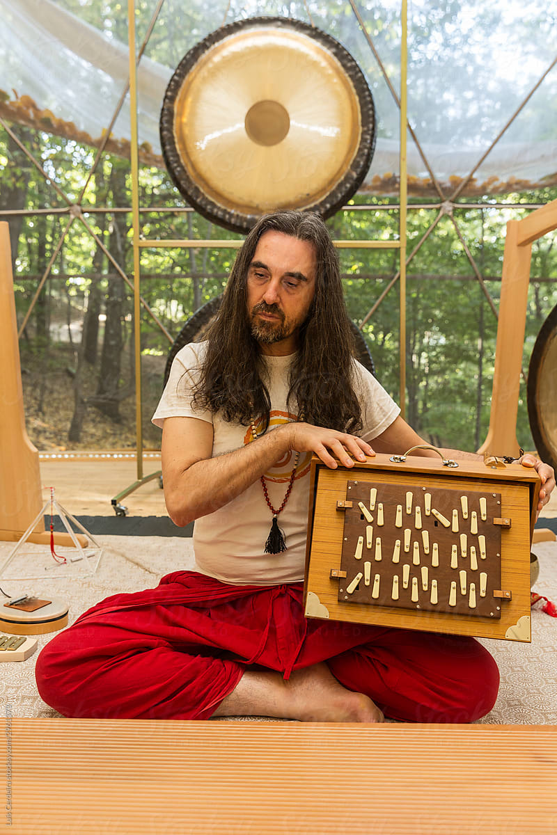 Therapist performing music therapy with a Shruti box