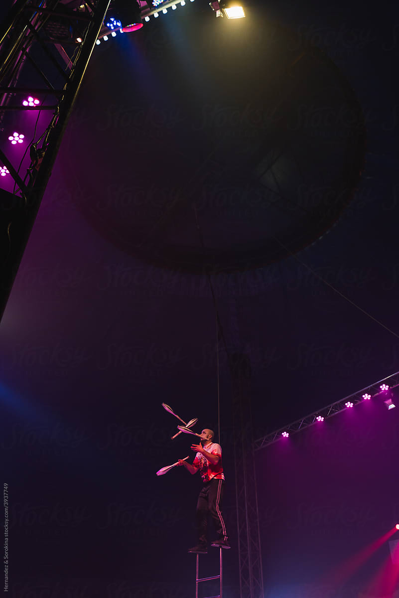 Flying Graceful Gymnast In Purple Lights