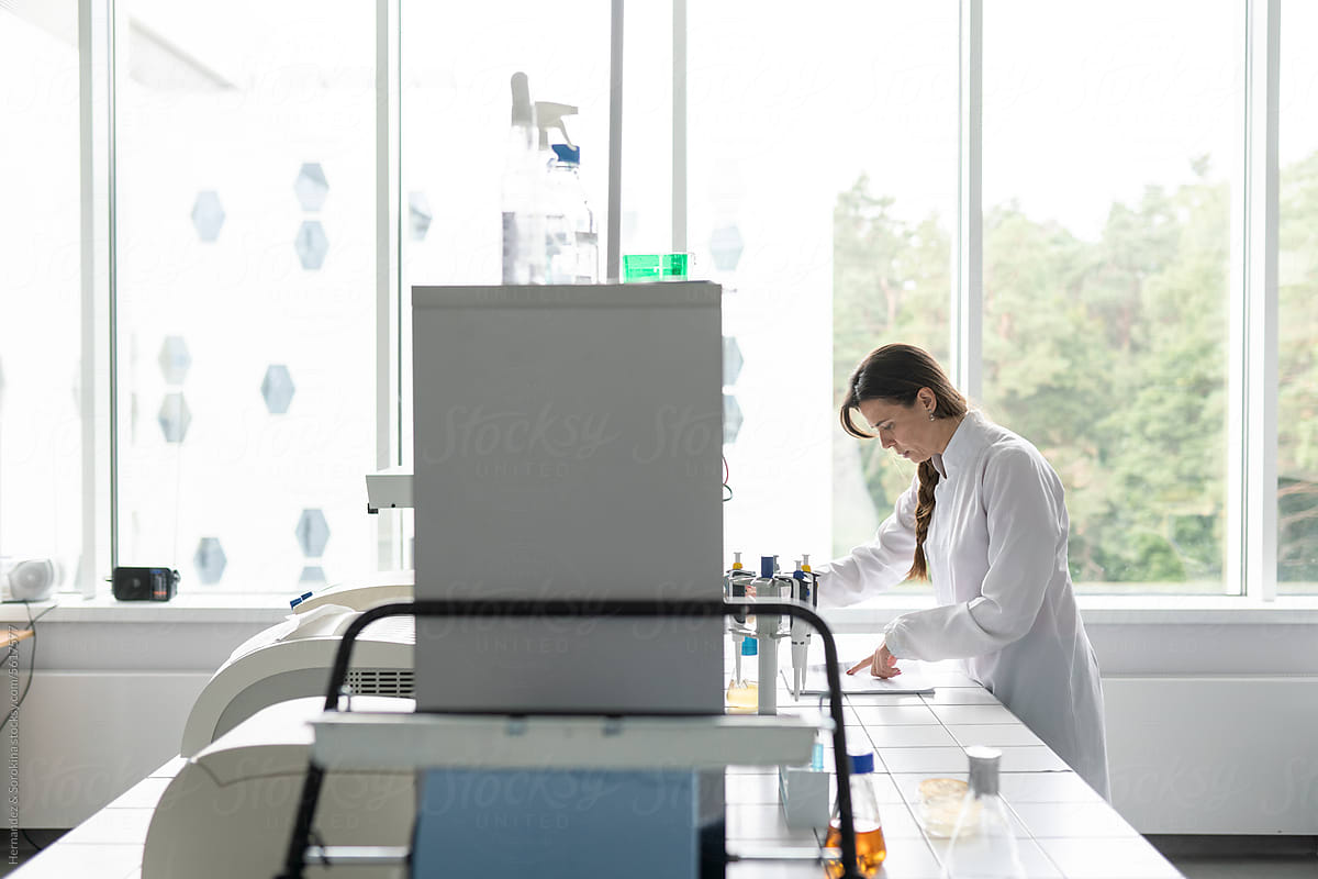 Female Scientist Working In Luminous Modern Lab