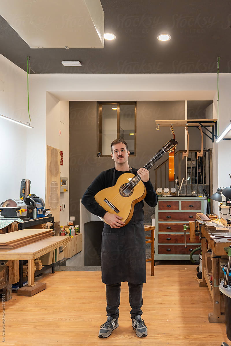 Portrait Of A Luthier, Guitar Maker In His Studio.