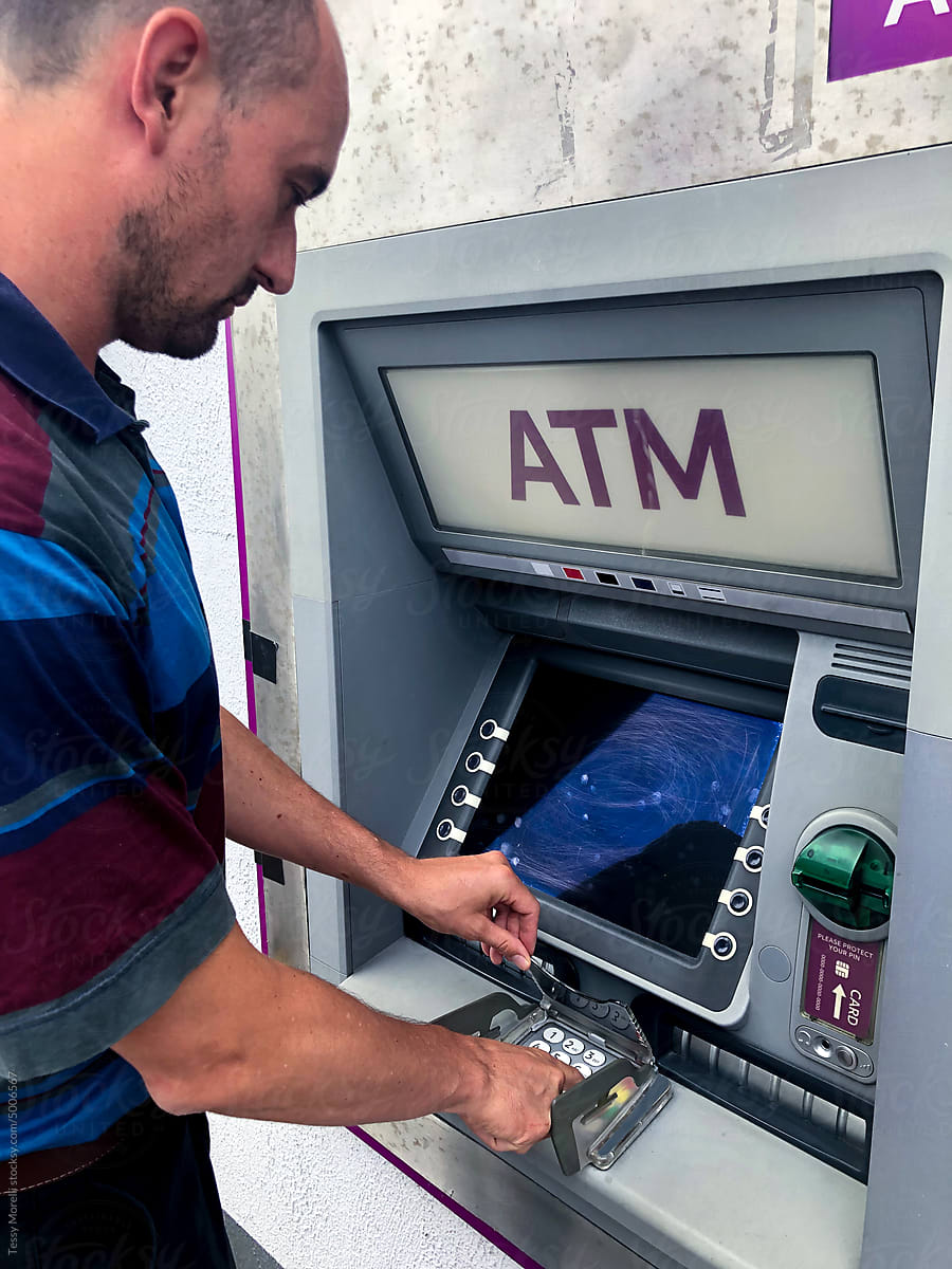 UGC man withdrawing money at ATM