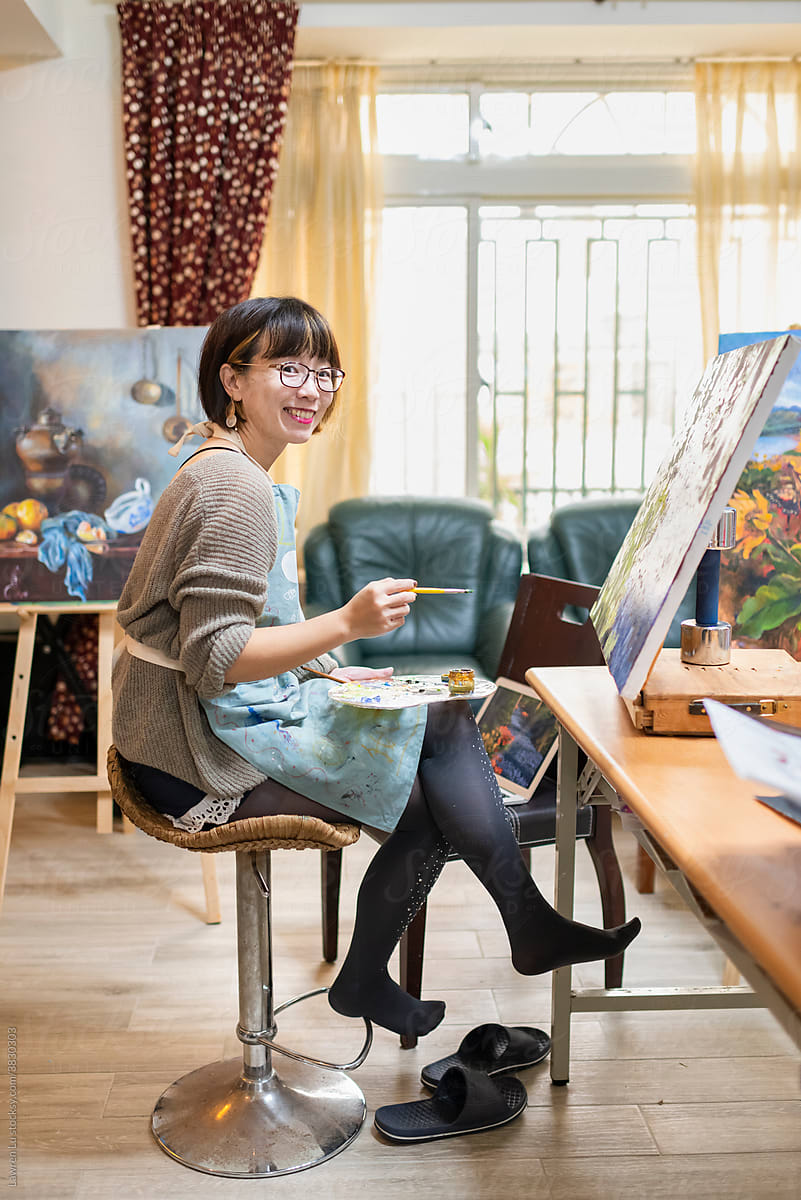 Female adult artist enjoys oil painting