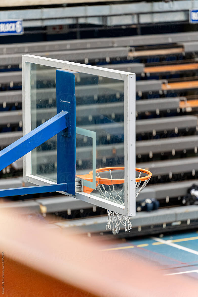 A basketball hoop seen from behind the backboard