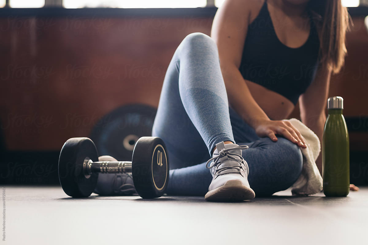 Unrecognizable woman resting after training in the gym