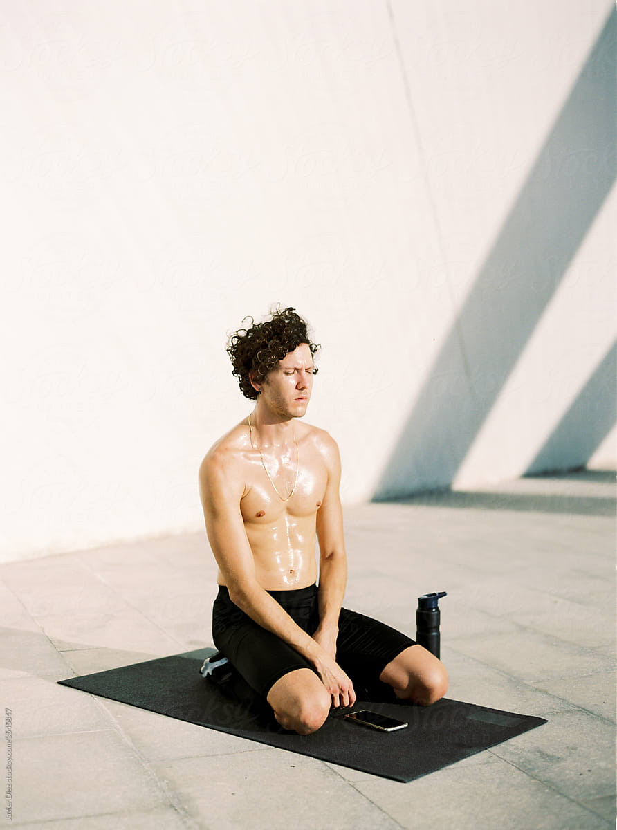 Sweaty sportsman resting during training