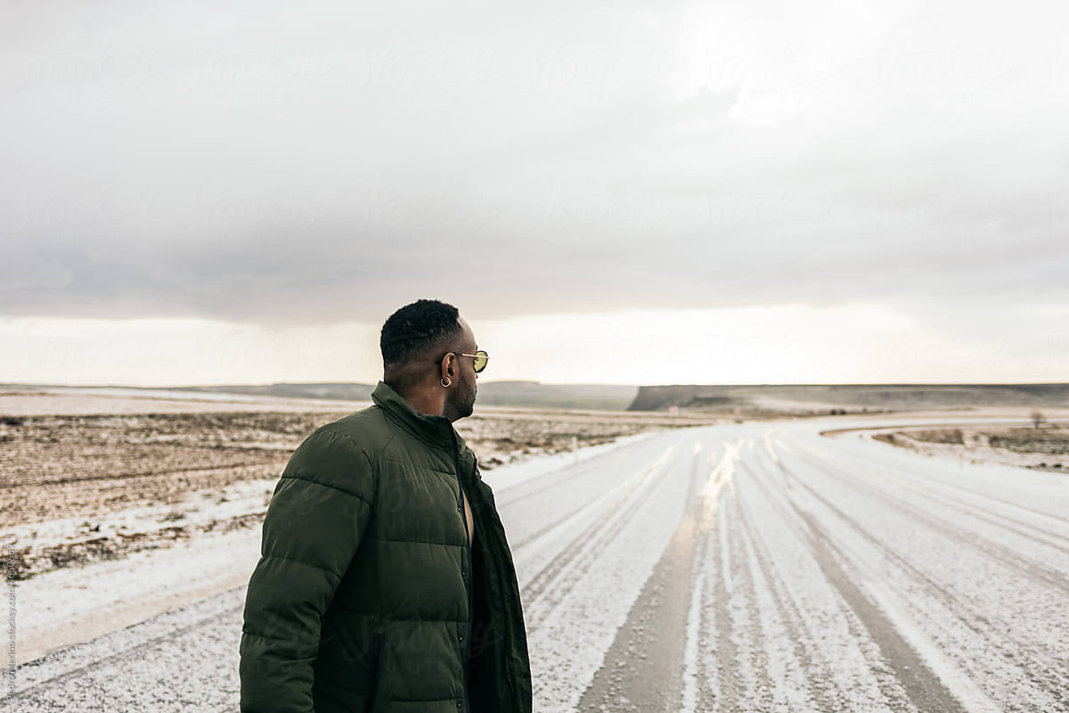 Stylish black man on a snowy road