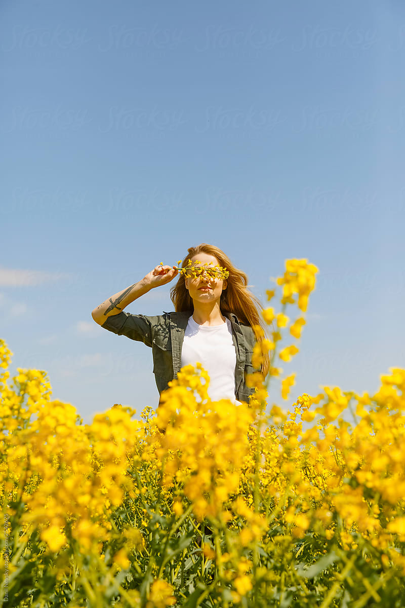 Young woman walking in the flower field