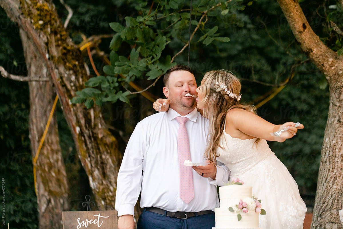 Bride Licking Frosting off Groom\'s Face