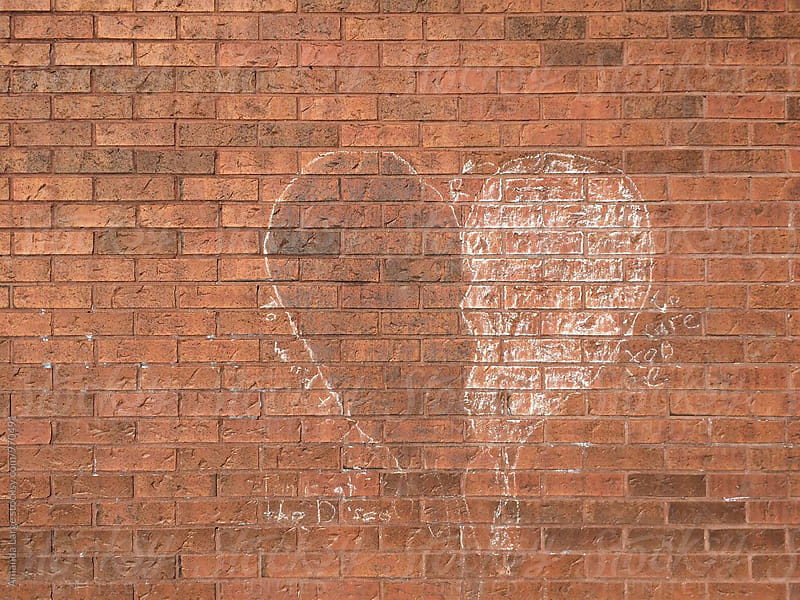Chalk heart on a red brick wall