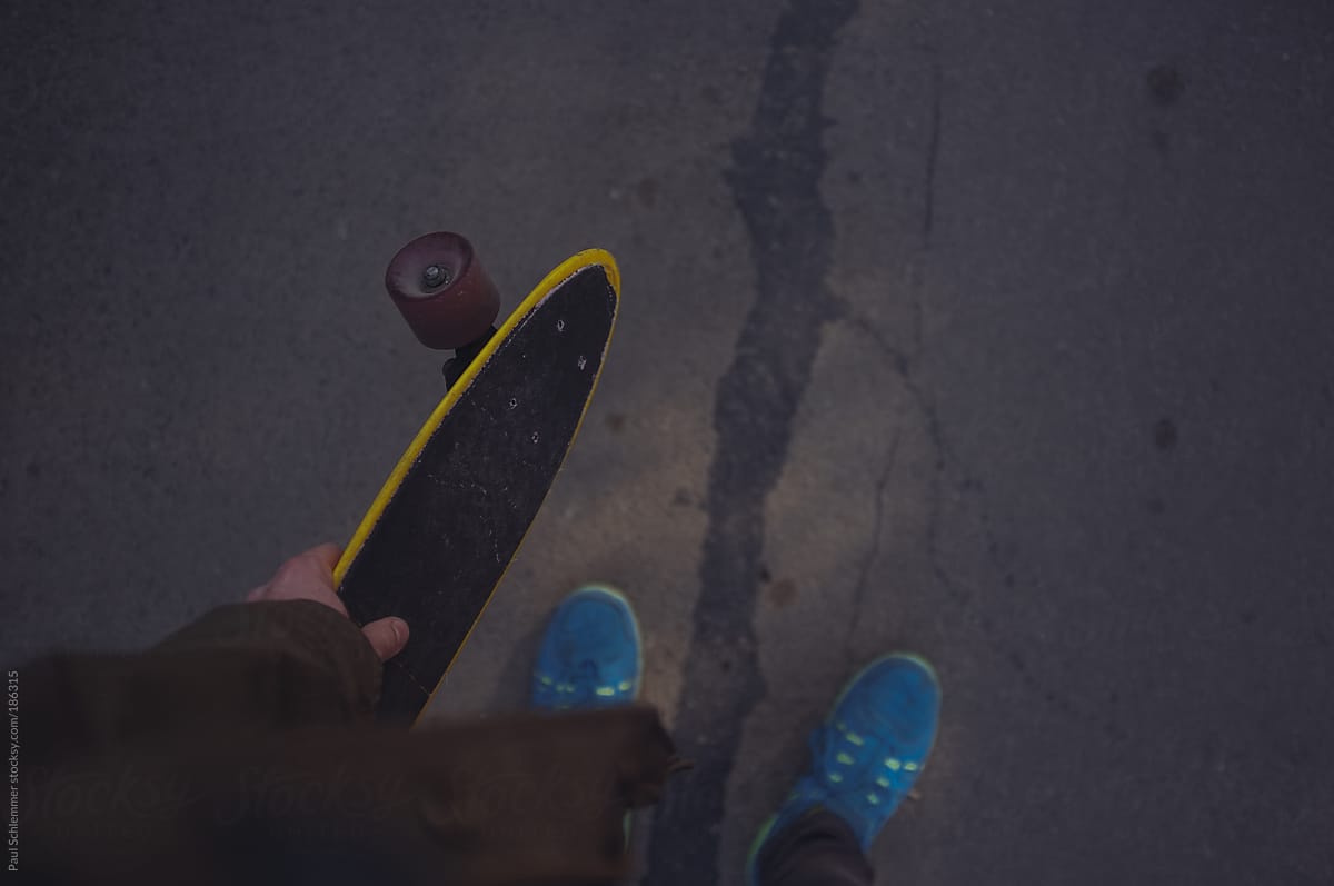 holding a plastic penny skateboard