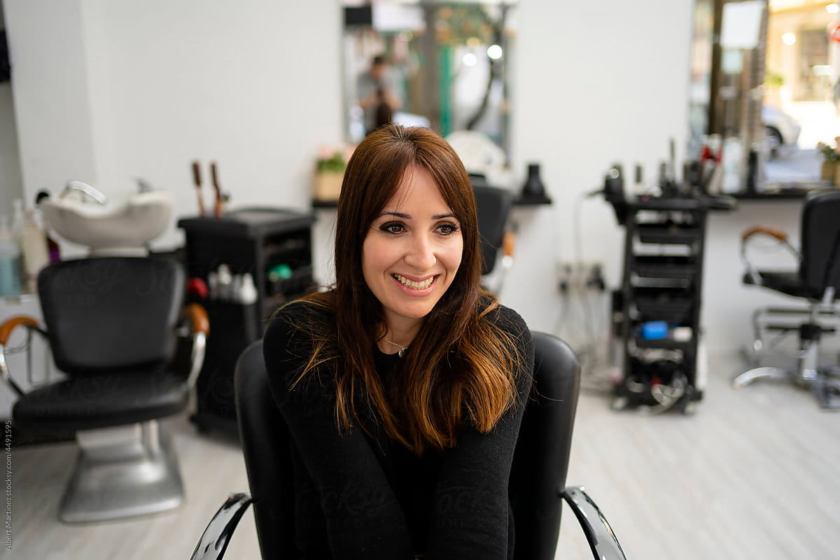 Smiling female sitting in salon