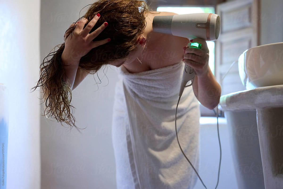 Woman drying her hair.