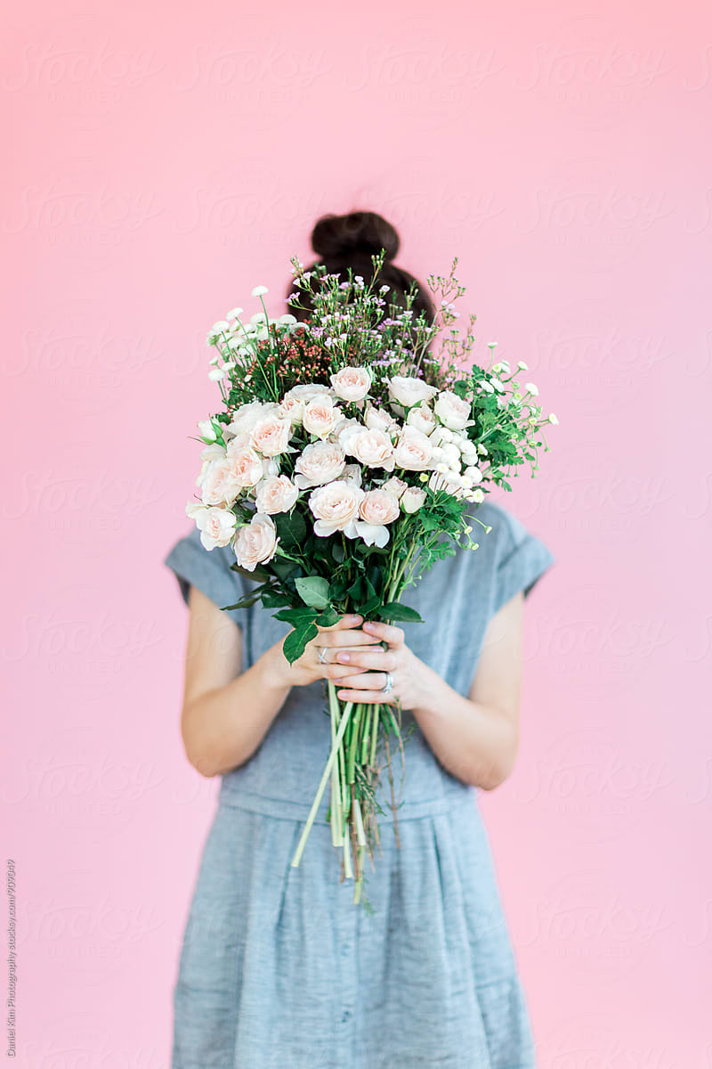 Girl Holding Flowers In Front Of Colorful Wall By Daniel Kim