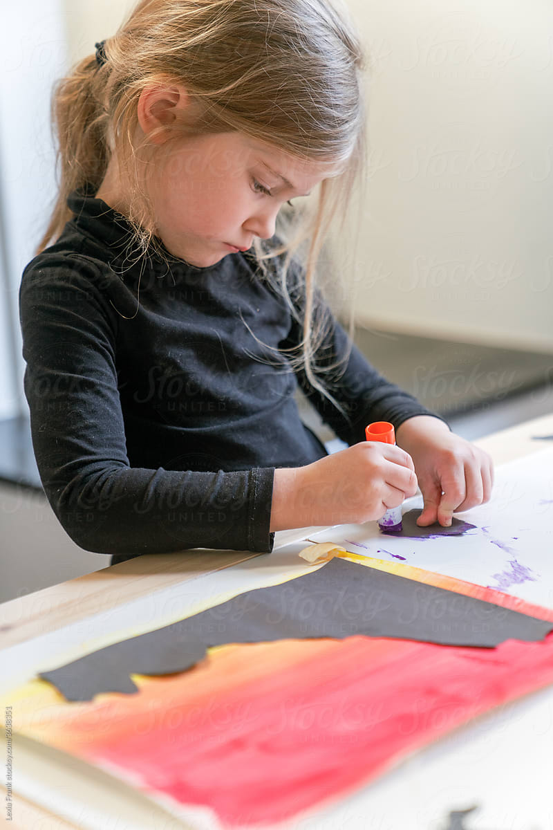 little girl works on art project