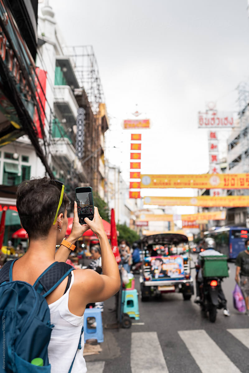 Tourist taking photos in chinatown.