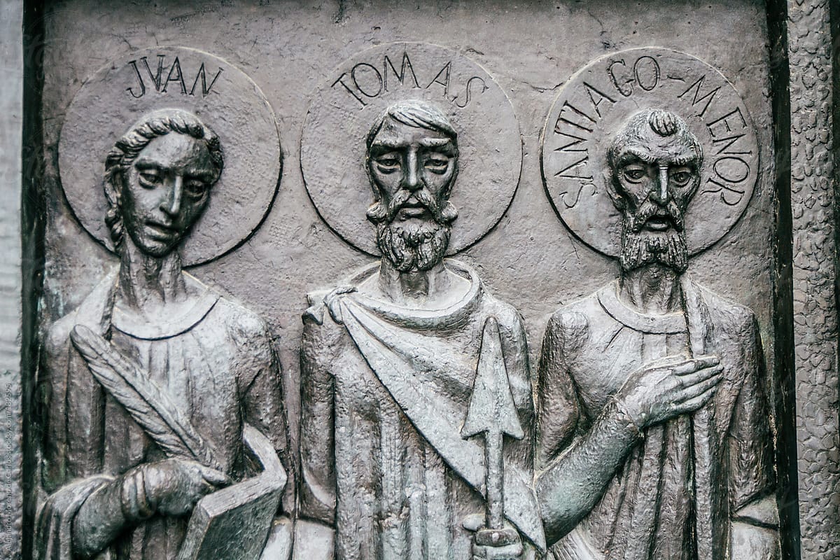 Relief sculpture of three apostles on christian cathedral