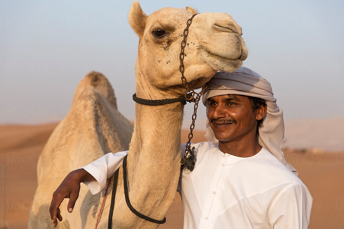 A Man Hugging his Camel