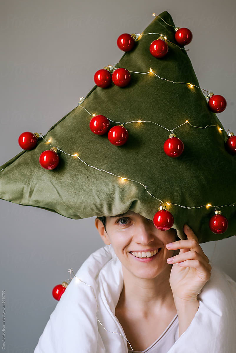 Cheerful young woman with pillow on her head.Christmas mood