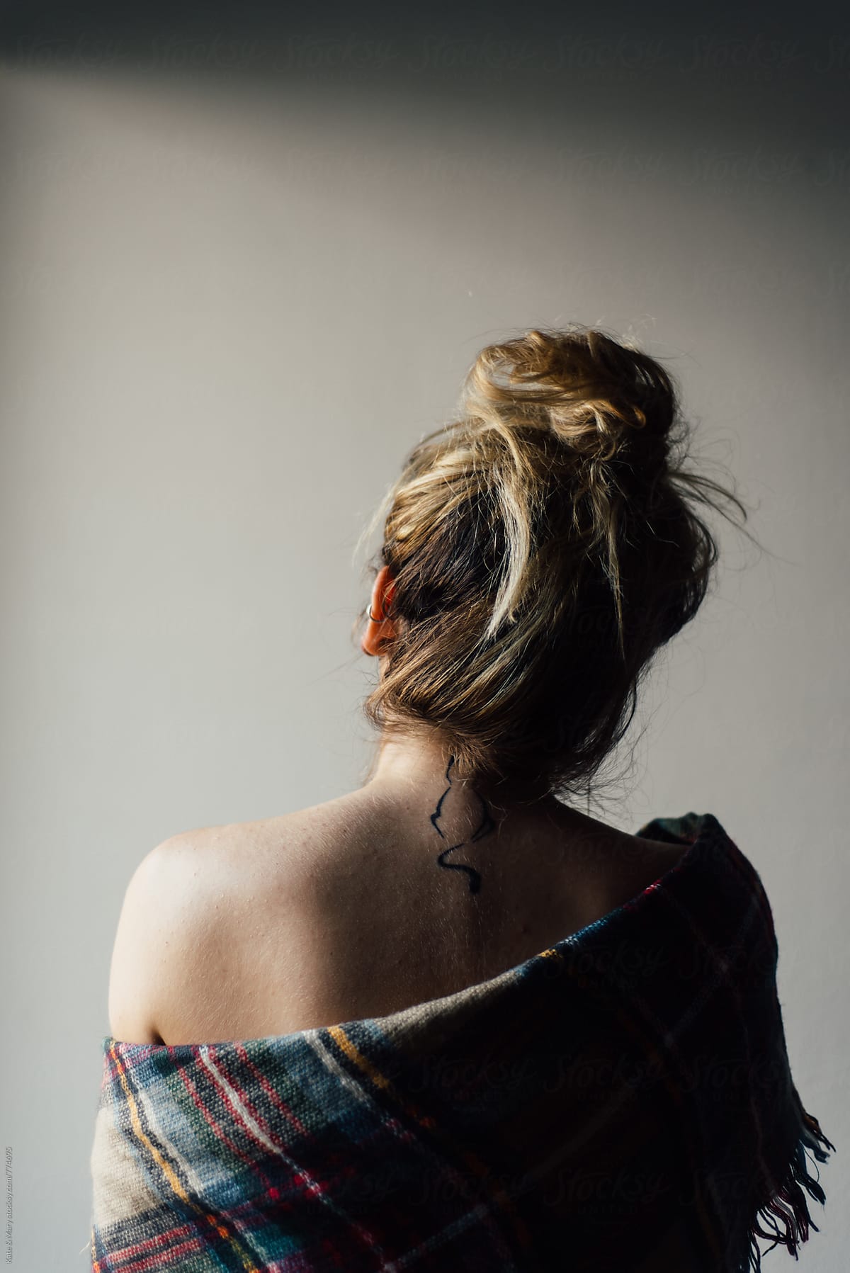 Back view of woman with cat tattoo