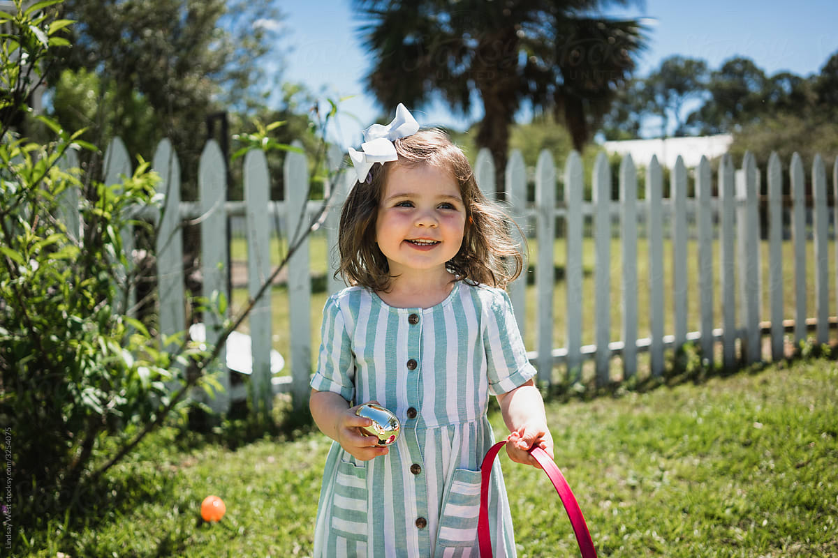 Little girl holding Easter basket.