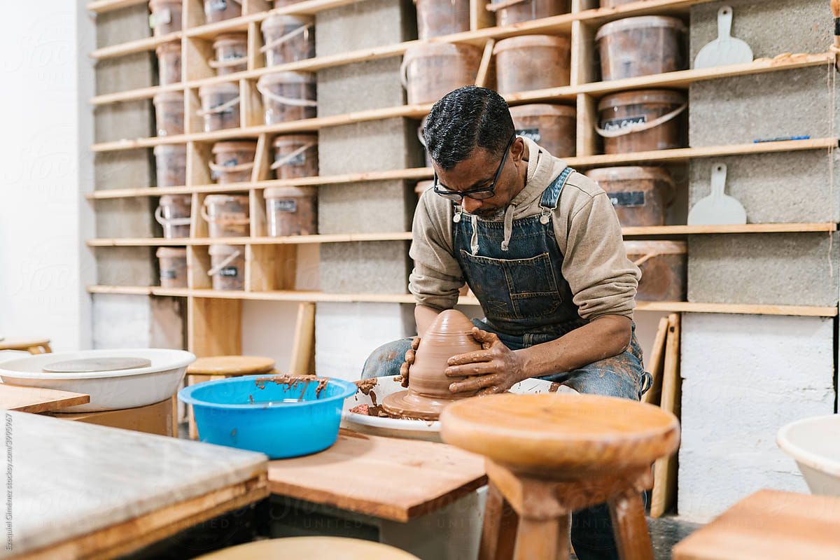 Ceramist working on the potter\'s wheel in the workshop