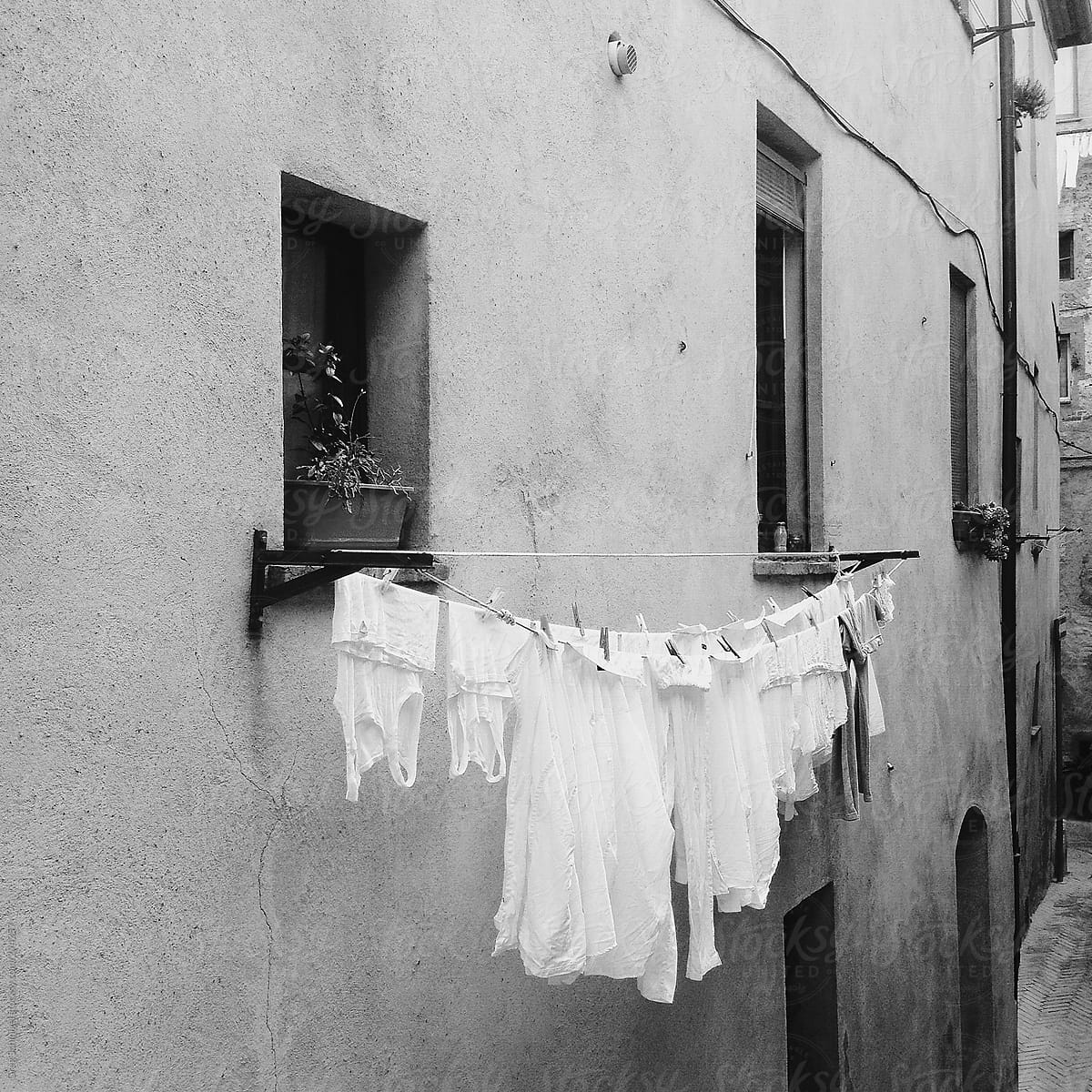 Fresh linen and laundry hanging to dry in a small town in Italy
