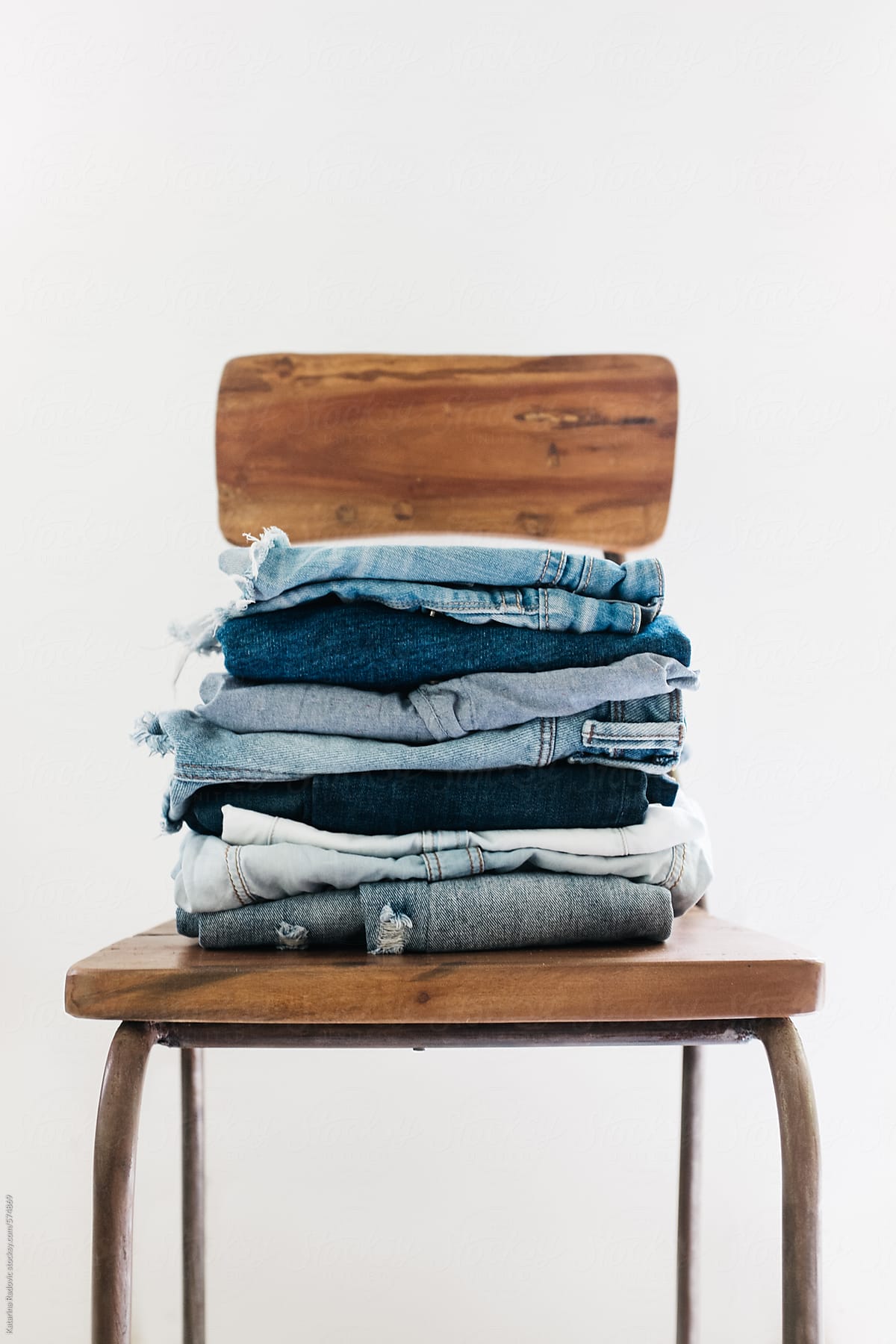 Stack of Denim on a Wooden Chair