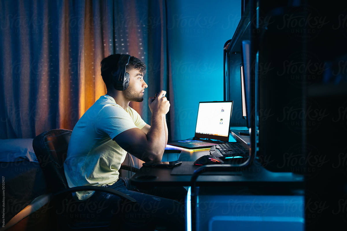 Young man playing video games on PC