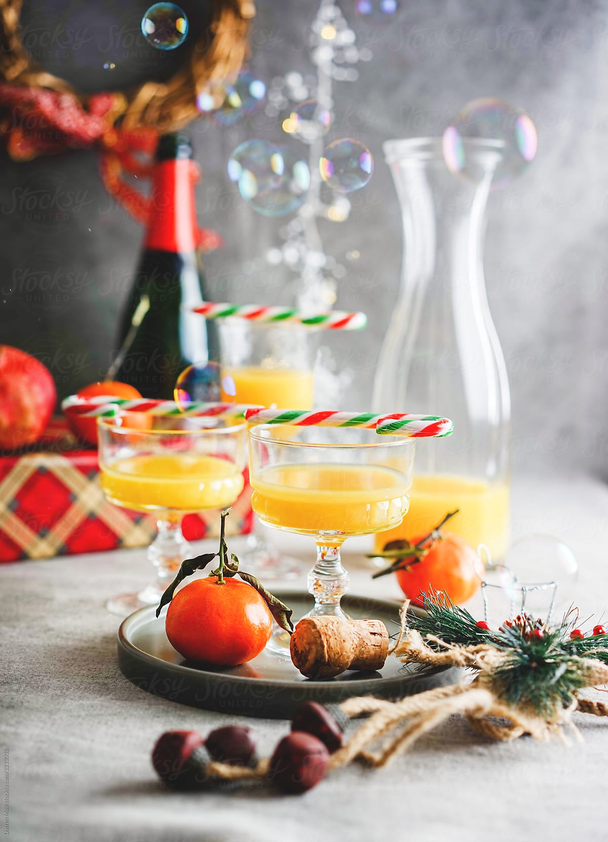 Bucks fizz drinks in festive setting.