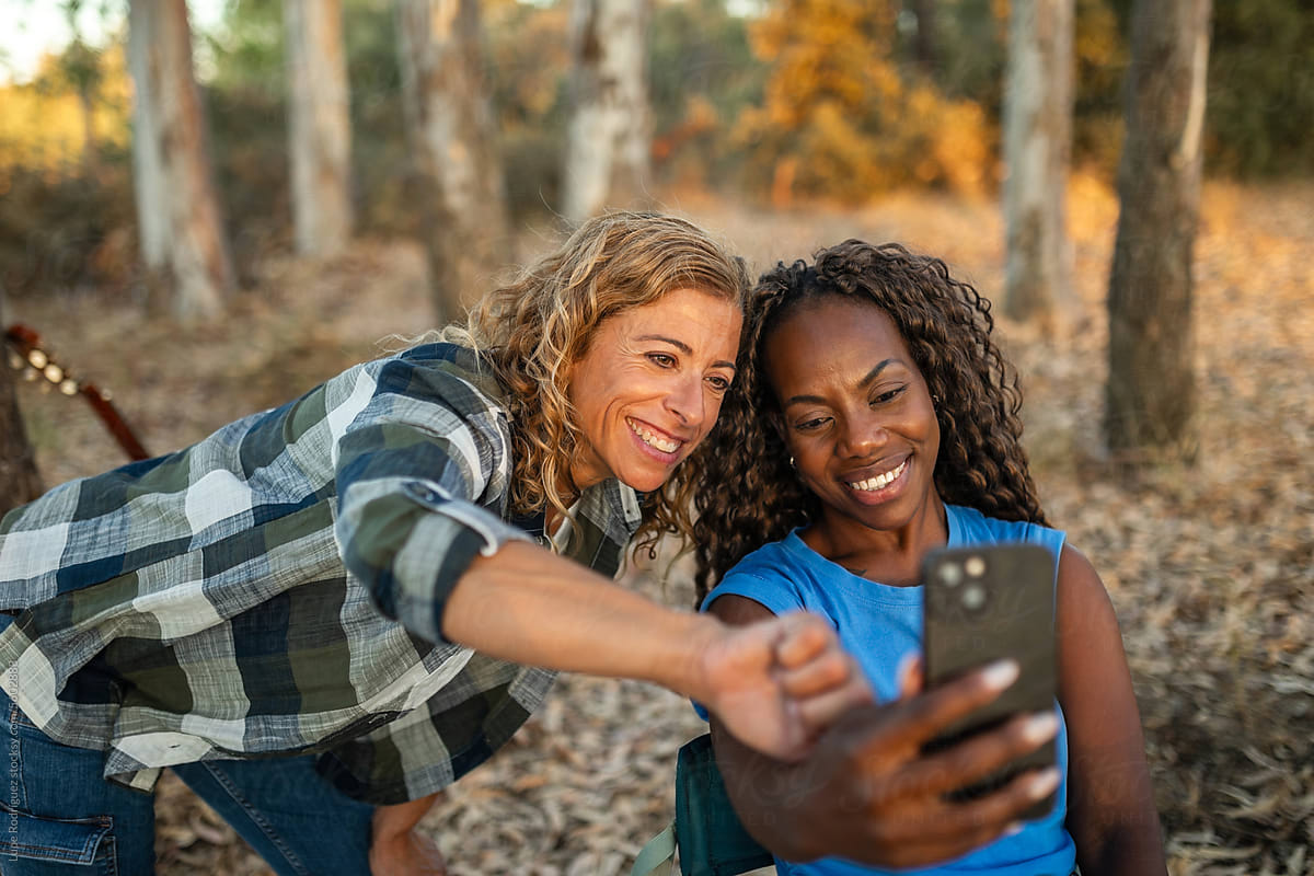 UGC selfie of two female friends of different ethnicity in a forest