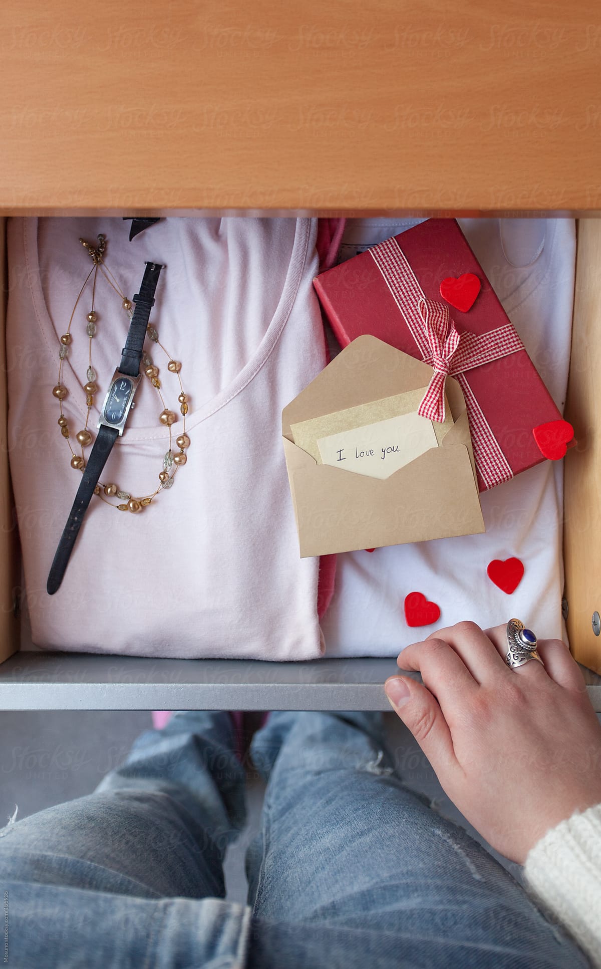 Woman Standing by the Drawer with Valentine\'s Gifts