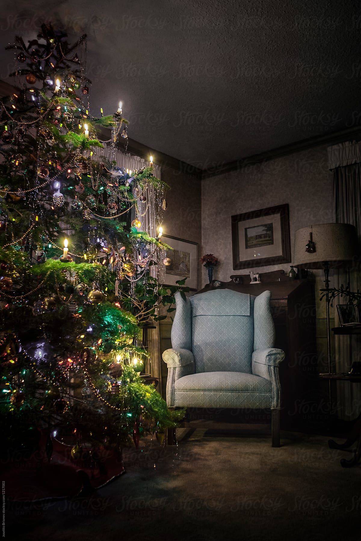Armchair and Christmas Tree Decorated and Lighted with Traditional Wax Candles