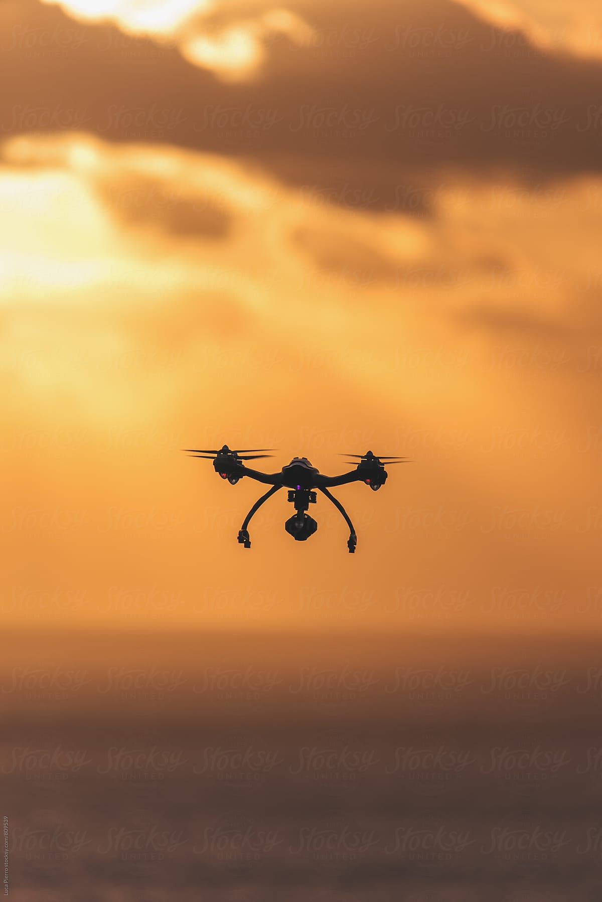 Drone flying in the cloudy sunset