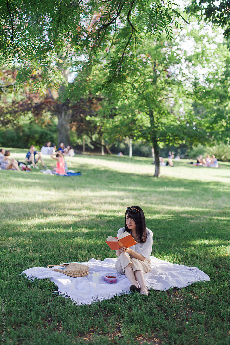 Brunette woman having a picnic in the park
