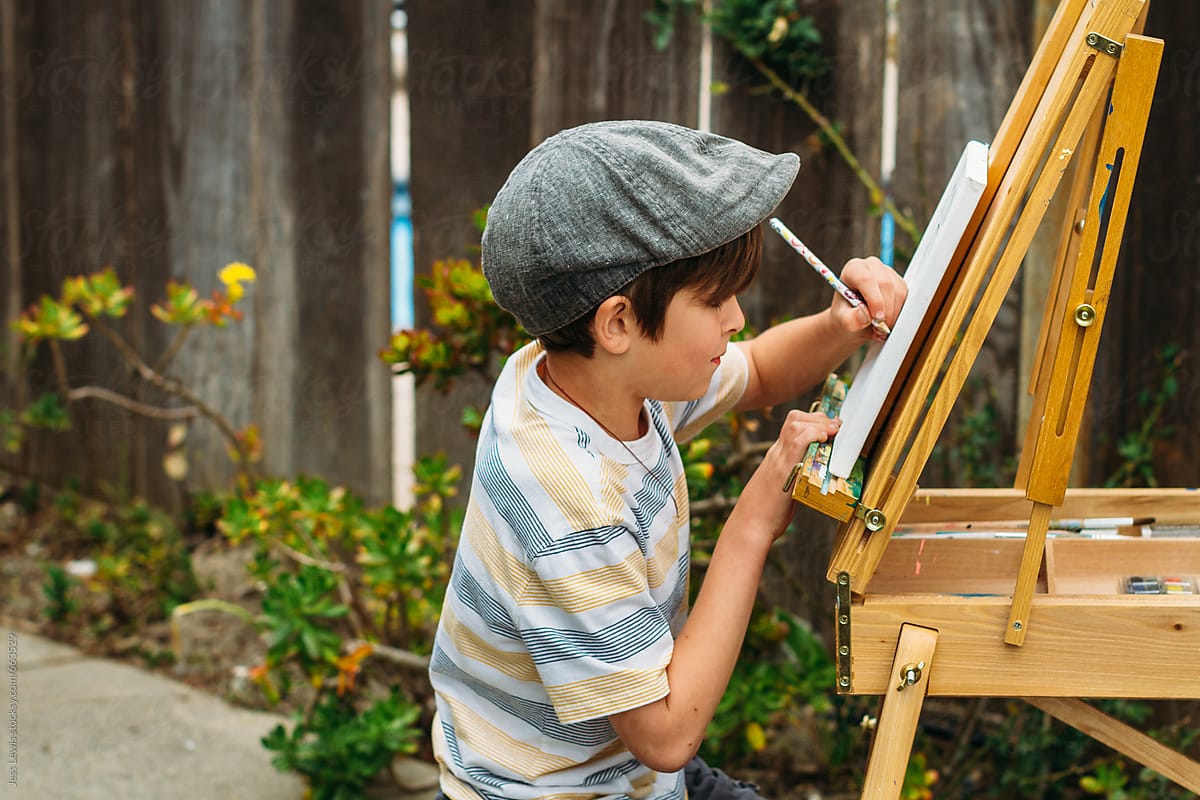 child drawing at an easel