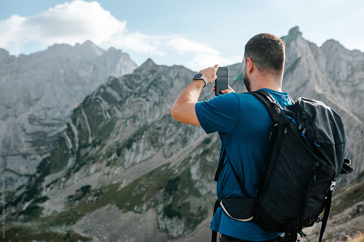 Man Taking Photos In Mountains.