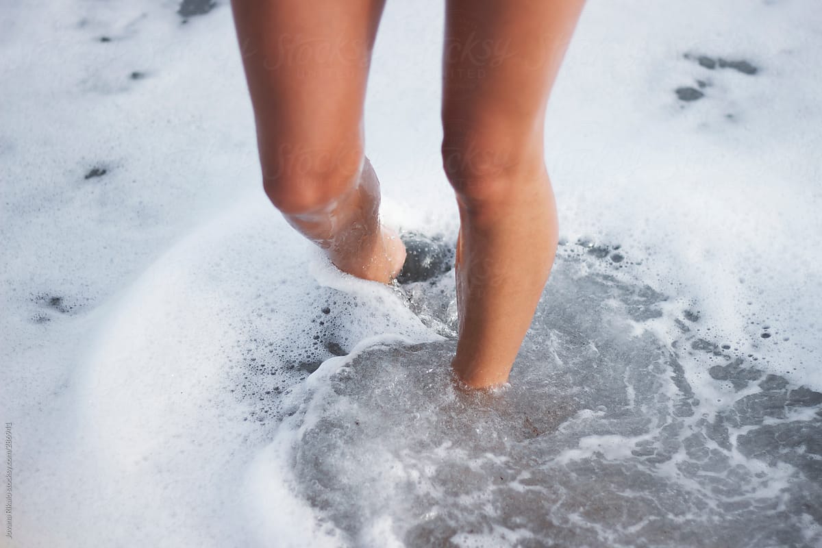 Woman\'s legs in clear sea water