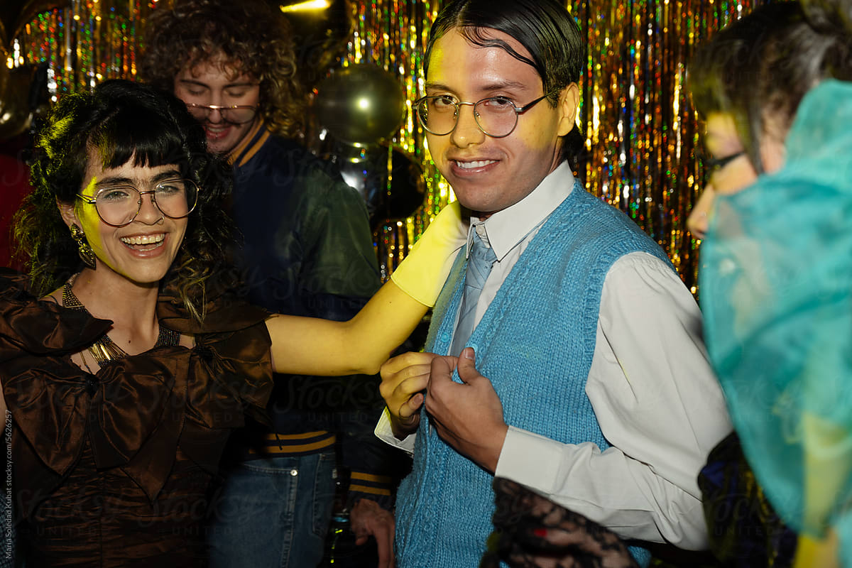 Young intercultural friends in smart elegant wear at costume party