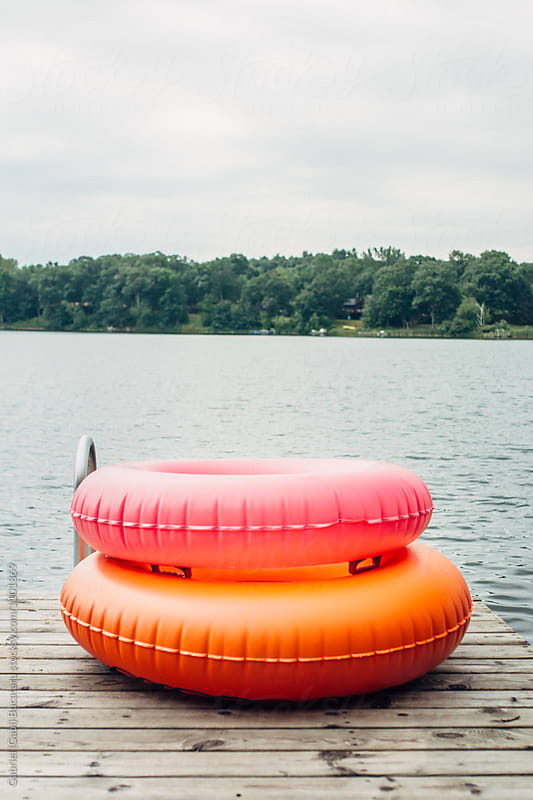 Pink and orange tubes by a lake