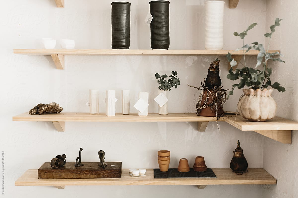 wooden shelves of vases, pots and plants