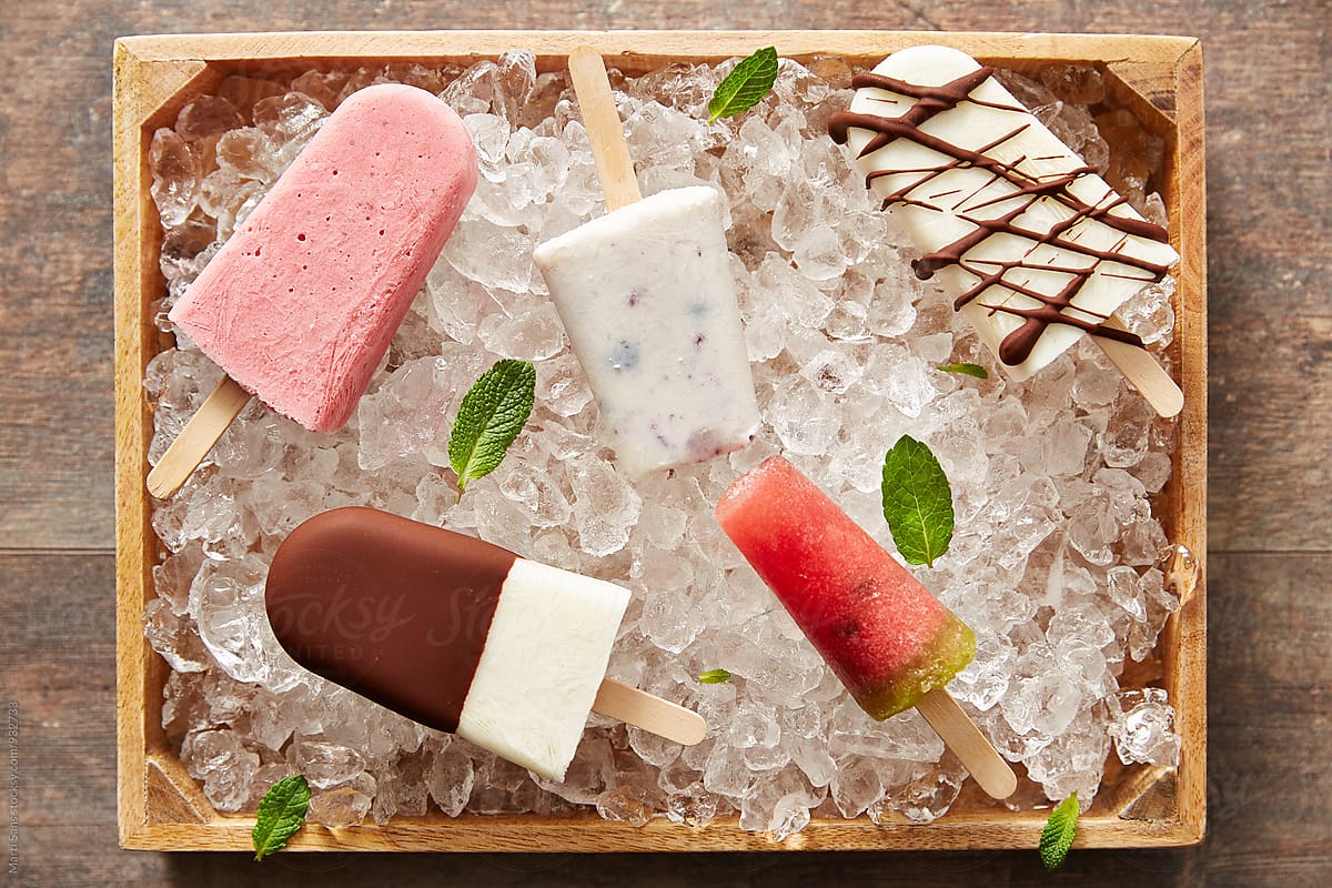 Five different popsicles on ice in basket