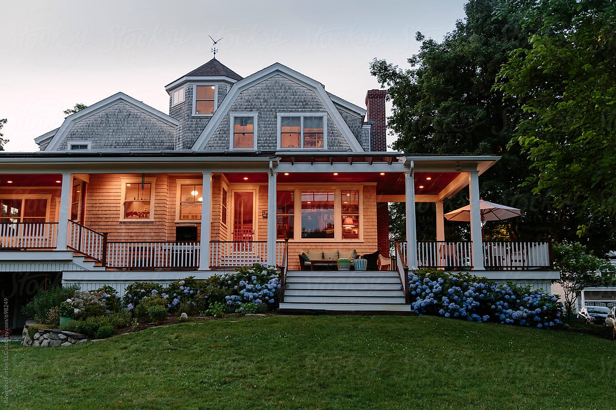 Craftsman House Exterior in summer at dusk with Hydrangea landscaping