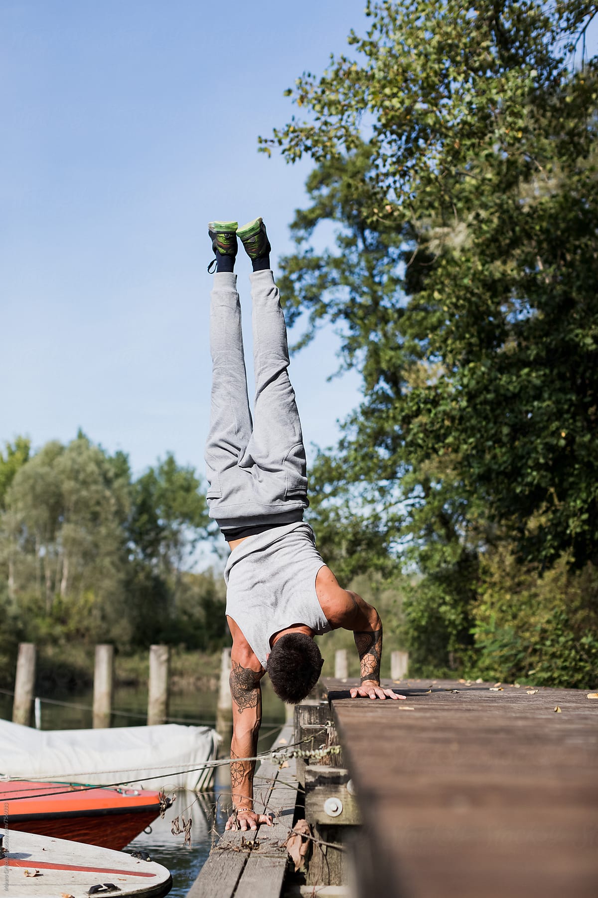 Acrobat doing Handstand pose in a jetty