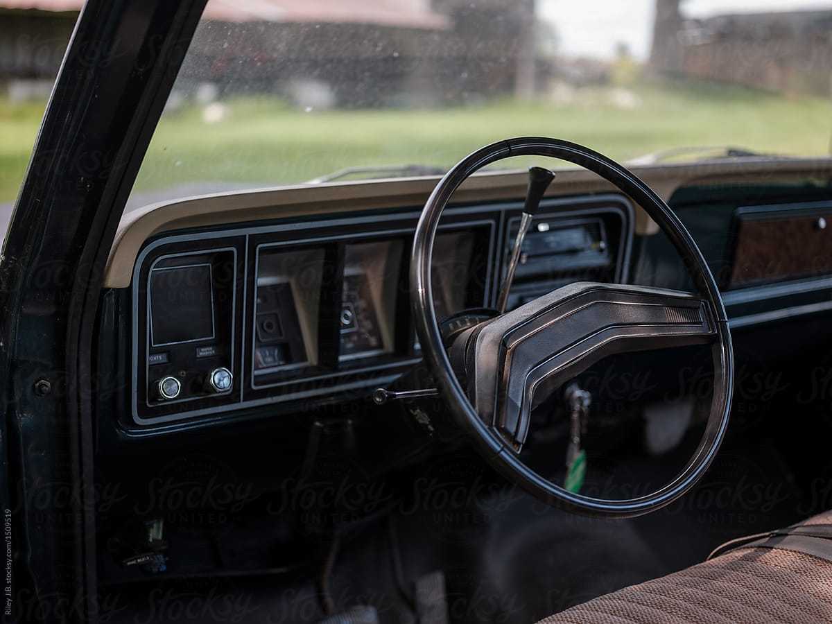 Steering wheel and dashboard in a vintage truck.