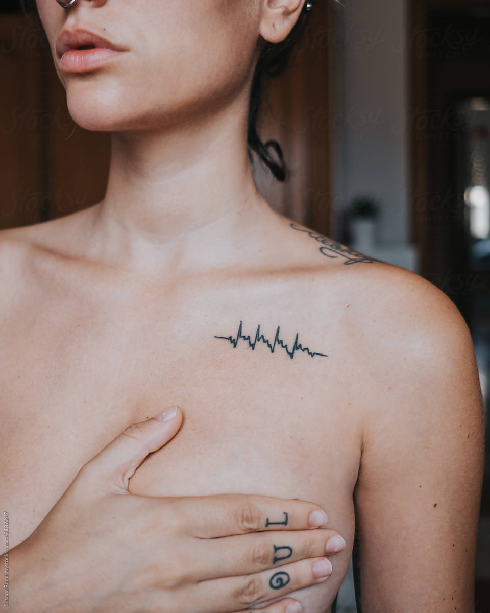 Chest Woman Detail With Tattooed Heartbeat by Stocksy Contributor