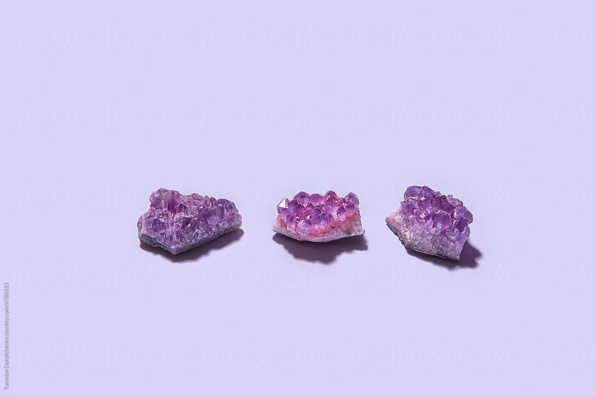 Natural amethyst crystal on purple background
