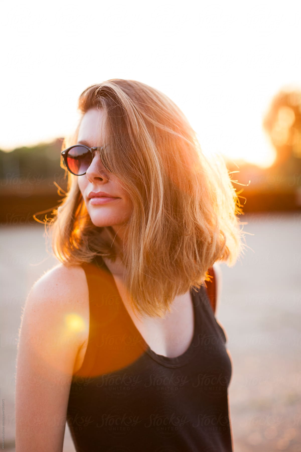 Woman With Casual Hair And Sunglasses On A Sunny Day By Stocksy