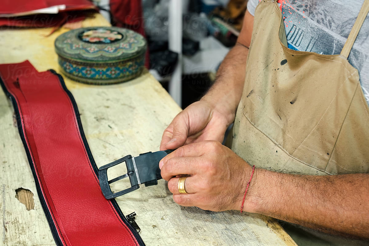 Leather worker repairing a belt