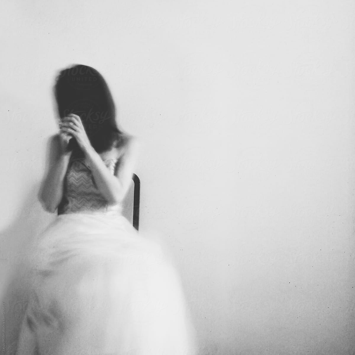 Woman Wearing An Evening Gown Holding Her Hair In Front Of Her Face Intentionally Blurred 0305